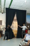Robyn Jensen and John Kort opening the curtains to the Rockets exhibit